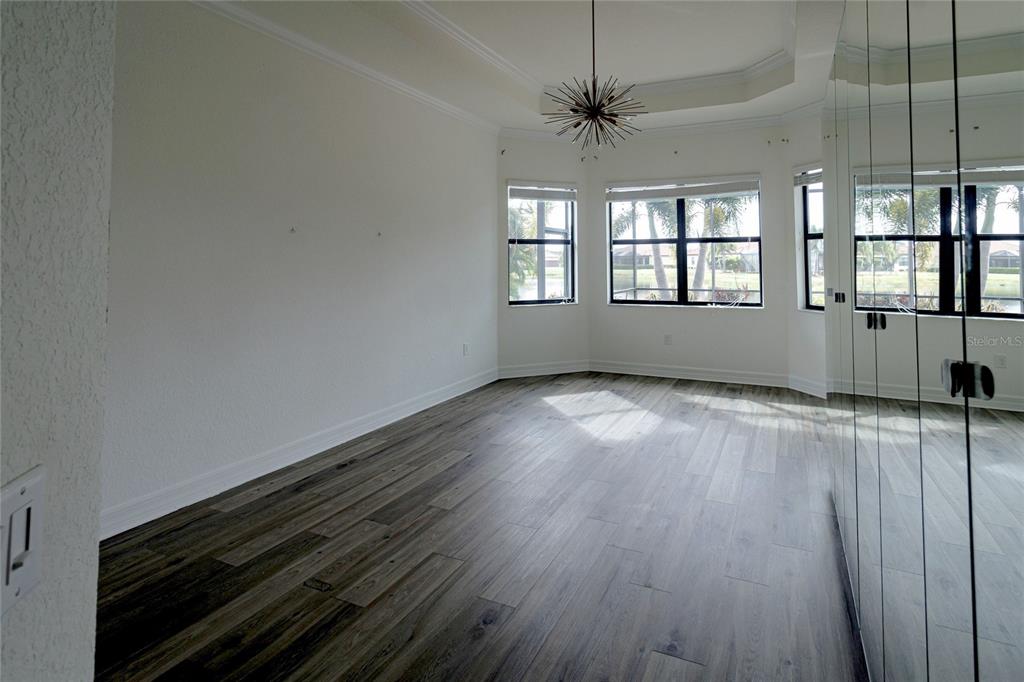 20315 Passagio Drive Venice, FL 34293 - Photo 14 of 40 wooden floor in an empty room with a window