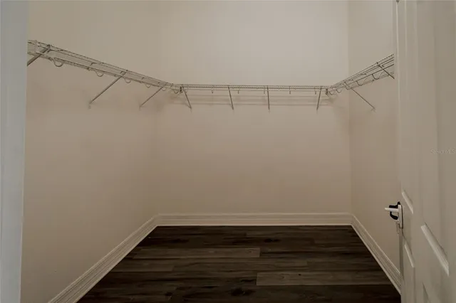 a bathroom with a granite countertop sink a mirror and a bathtub
