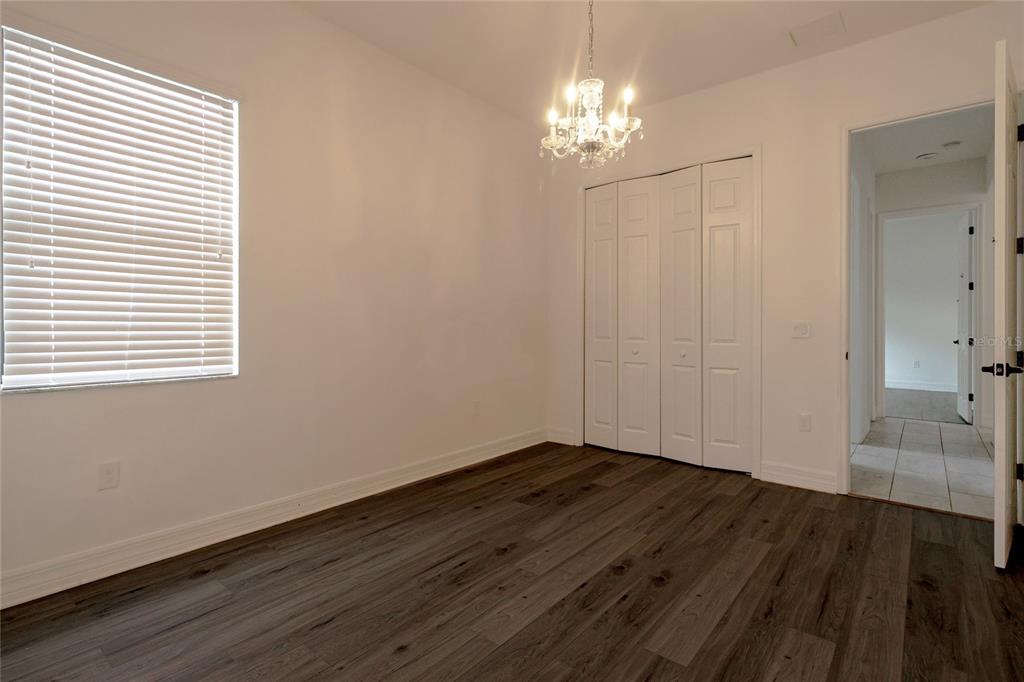 20315 Passagio Drive Venice, FL 34293 - Photo 18 of 40 a view of a livingroom with wooden floor and a chandelier
