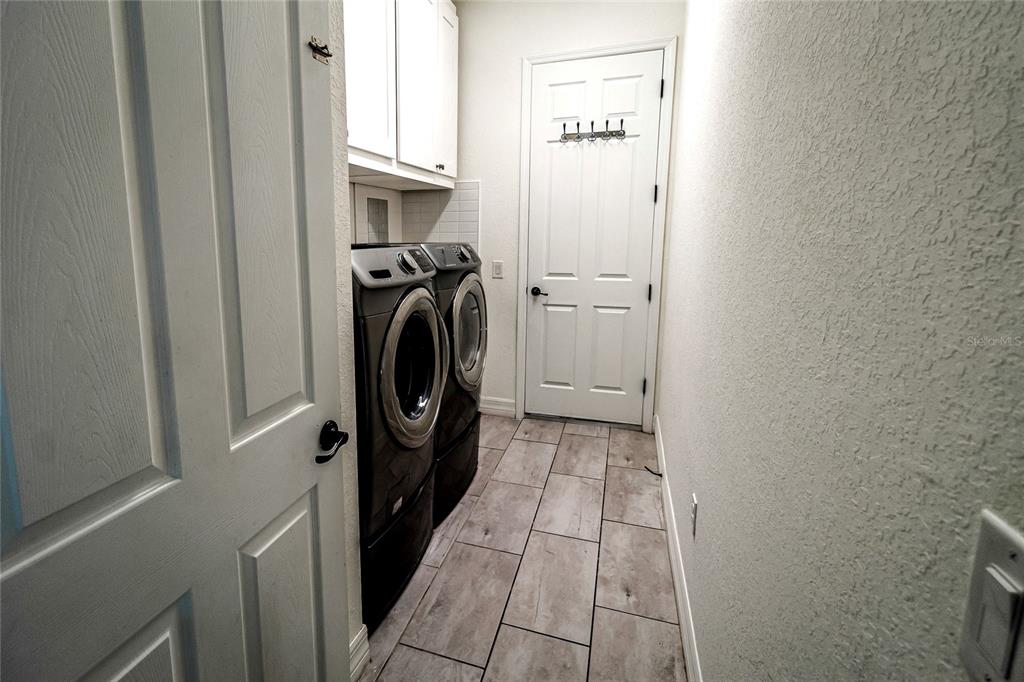 20315 Passagio Drive Venice, FL 34293 - Photo 20 of 40 a view of a storage & utility room with a washer dryer