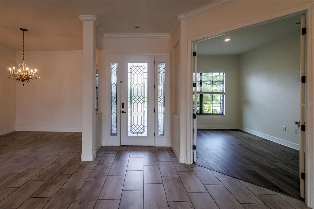 20315 Passagio Drive Venice, FL 34293 - Photo 5 of 40 an empty room with wooden floor and windows