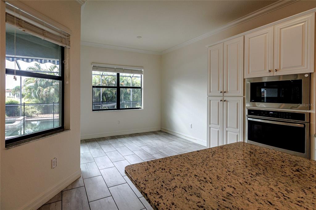 20315 Passagio Drive Venice, FL 34293 - Photo 6 of 40 a kitchen with a stove a sink and a microwave