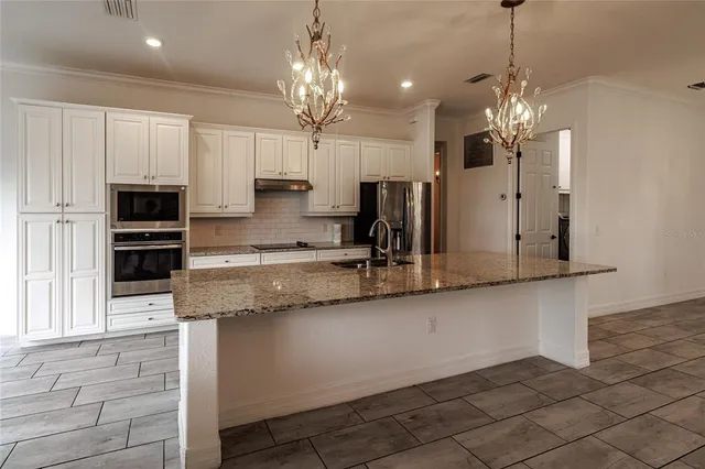 a kitchen with a sink and a refrigerator