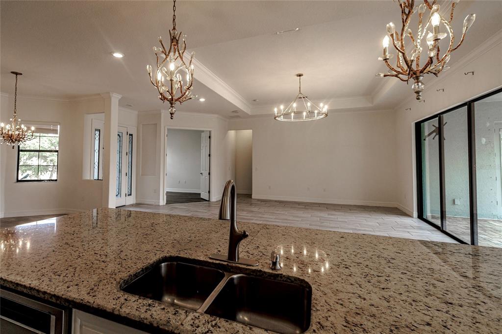 20315 Passagio Drive Venice, FL 34293 - Photo 9 of 40 a kitchen with a sink and a refrigerator