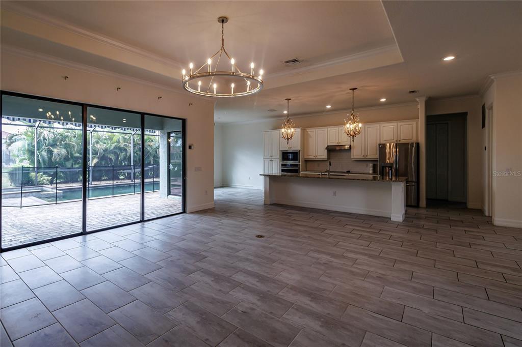 20315 Passagio Drive Venice, FL 34293 - Photo 10 of 40 a view of a big room with chandelier and windows