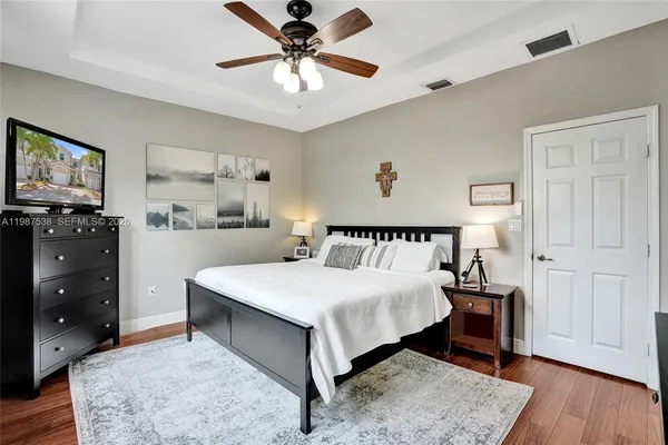 a view of kitchen with wooden floor and electronic appliances