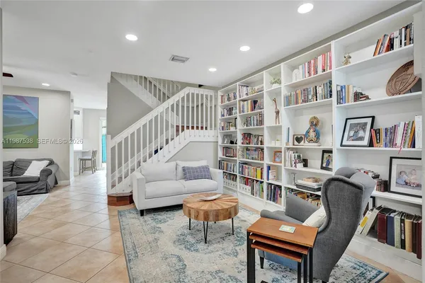 a living room with furniture and a book shelf