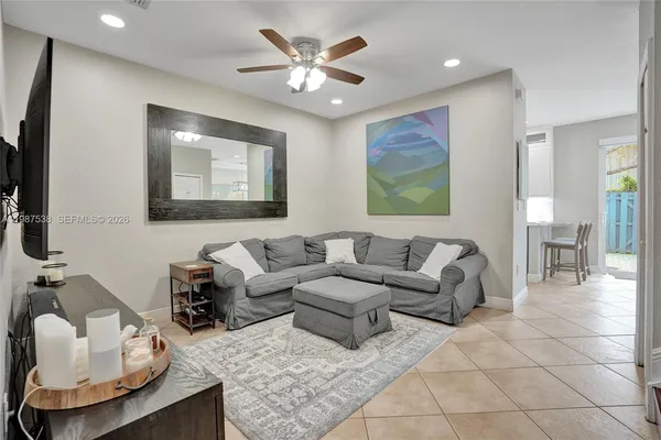 a living room with furniture ceiling fan and a rug