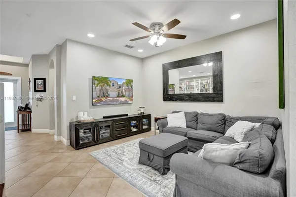 a living room with furniture and a painting