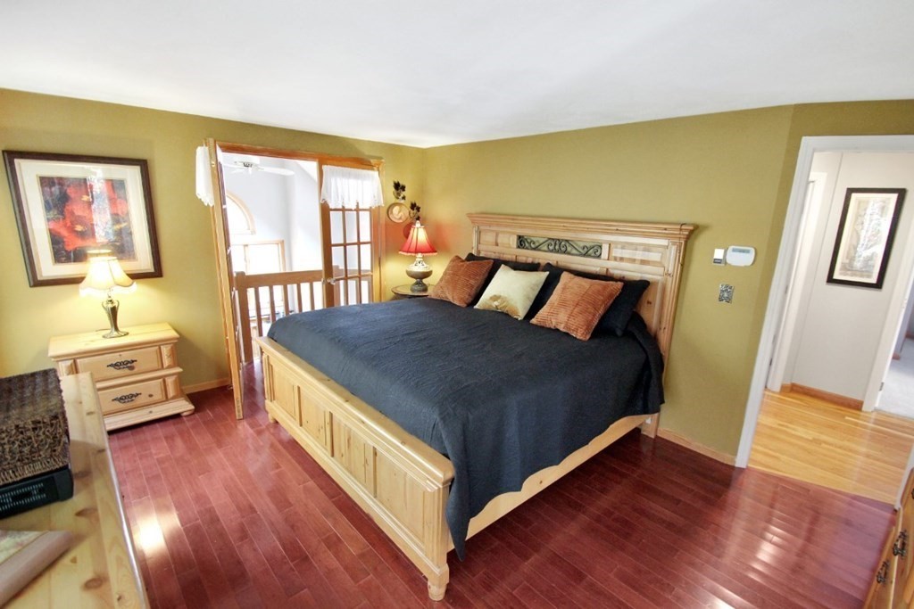 6 Patterson Road Shirley, MA 01464 - Photo 14 of 27 a large bedroom with a bed and wooden floor