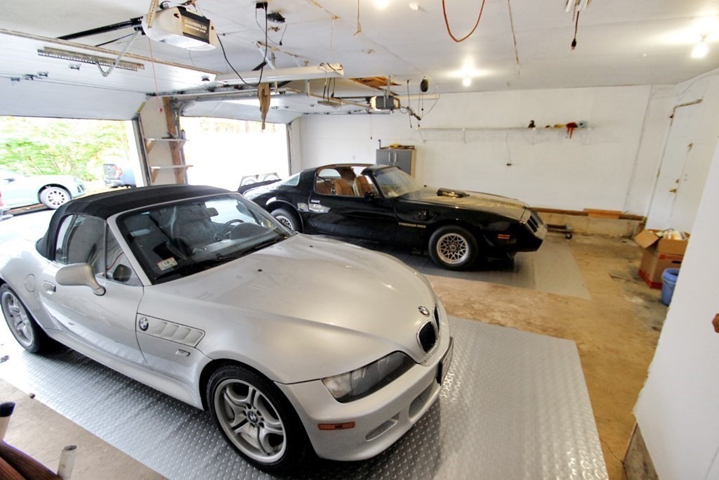 6 Patterson Road Shirley, MA 01464 - Photo 21 of 27 a car and bike parked in a garage