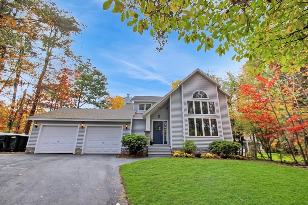 6 Patterson Road Shirley, MA 01464 - Photo 3 of 27 a front view of a house with a yard and garage