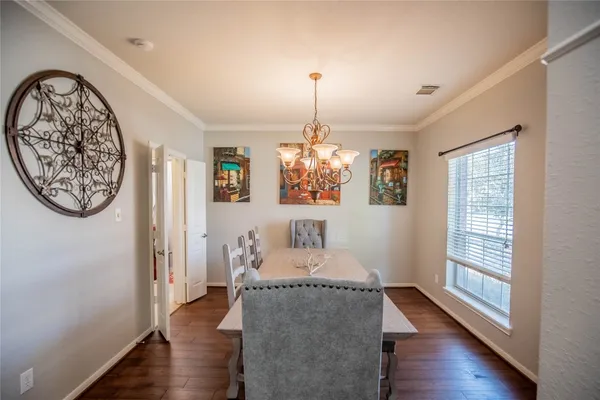 a living room with furniture a window and wooden floor