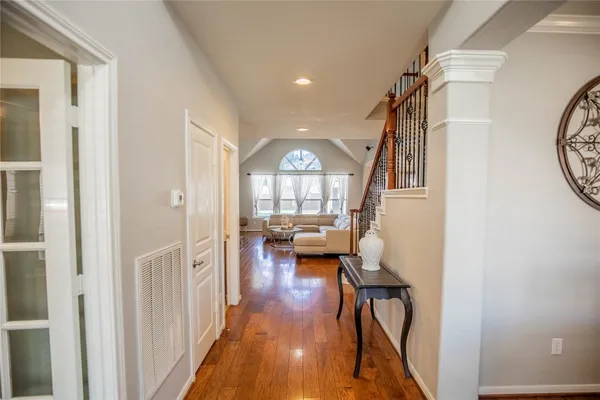 a view of entryway with wooden floor and a livingroom