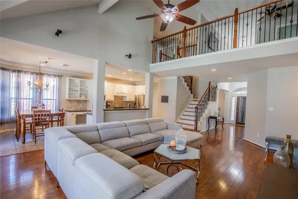 a living room with furniture and wooden floor