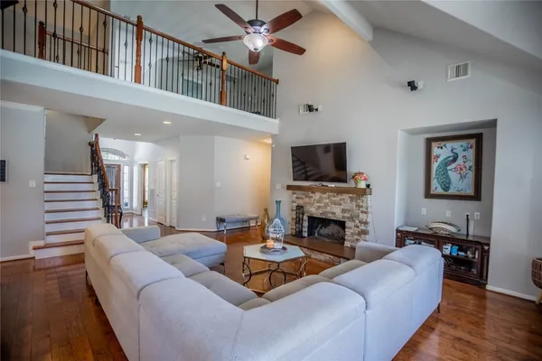 a living room with furniture a fireplace and a flat screen tv