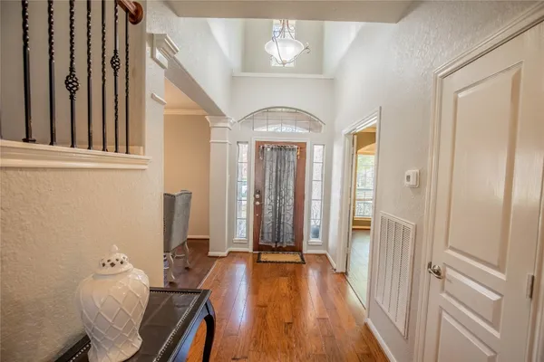 a view of a hallway with furniture and wooden floor