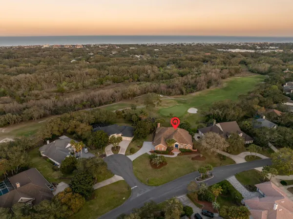 a bedroom with a bed a dresser and next to a window