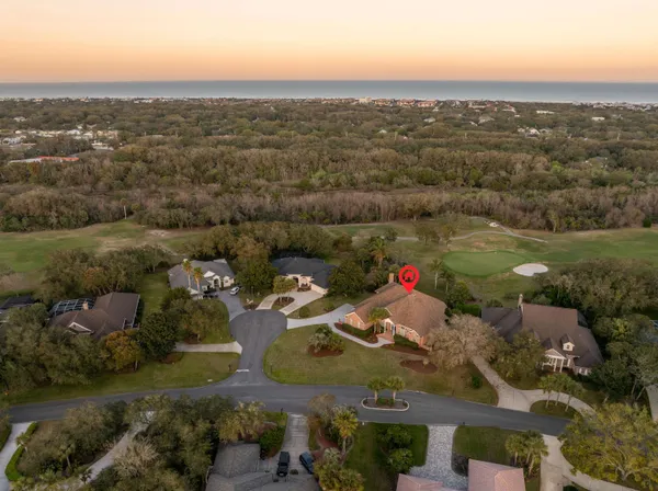 a view of a patio with furniture and a table and chairs under an umbrella