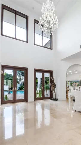 a view of a hallway with wooden floor and windows