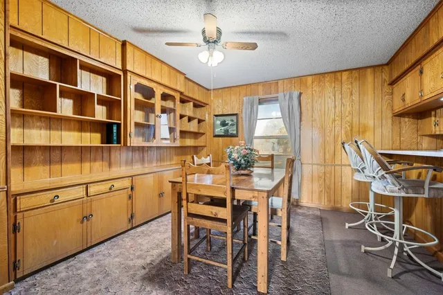 a view of a dining room with furniture and chandelier