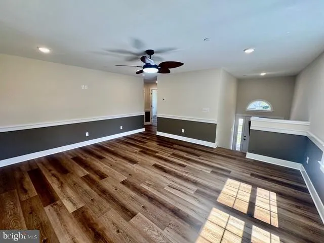 a kitchen with granite countertop white cabinets and refrigerator