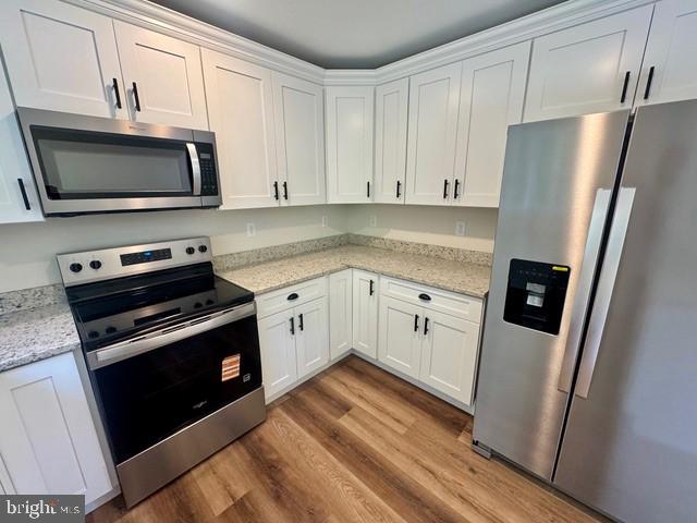 Harbor Drive Chester, MD 21619 - Photo 5 of 12 a kitchen with white cabinets and stainless steel appliances