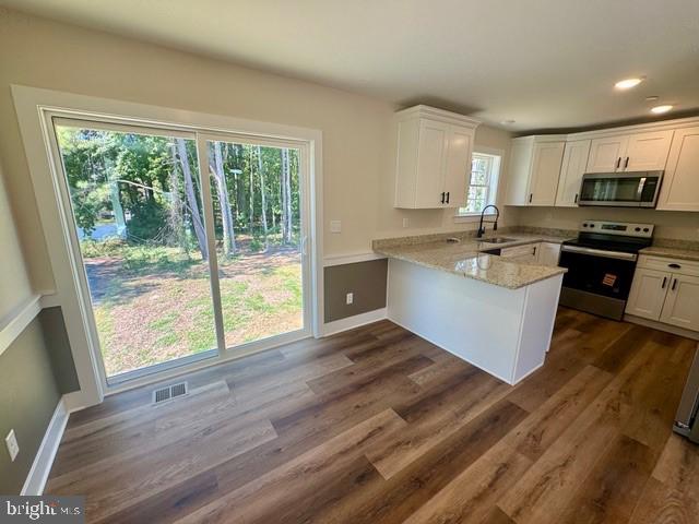 Harbor Drive Chester, MD 21619 - Photo 8 of 12 a kitchen with stainless steel appliances granite countertop a stove a sink and a refrigerator