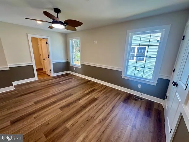 a view of a hallway with wooden floor and a hallway
