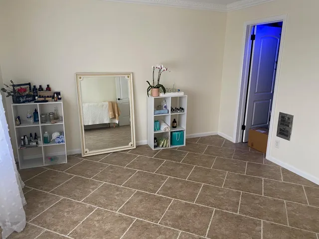a room with a furniture and a book shelf