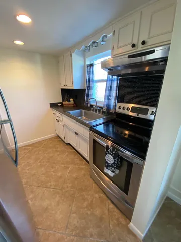 a kitchen with a stove and a sink