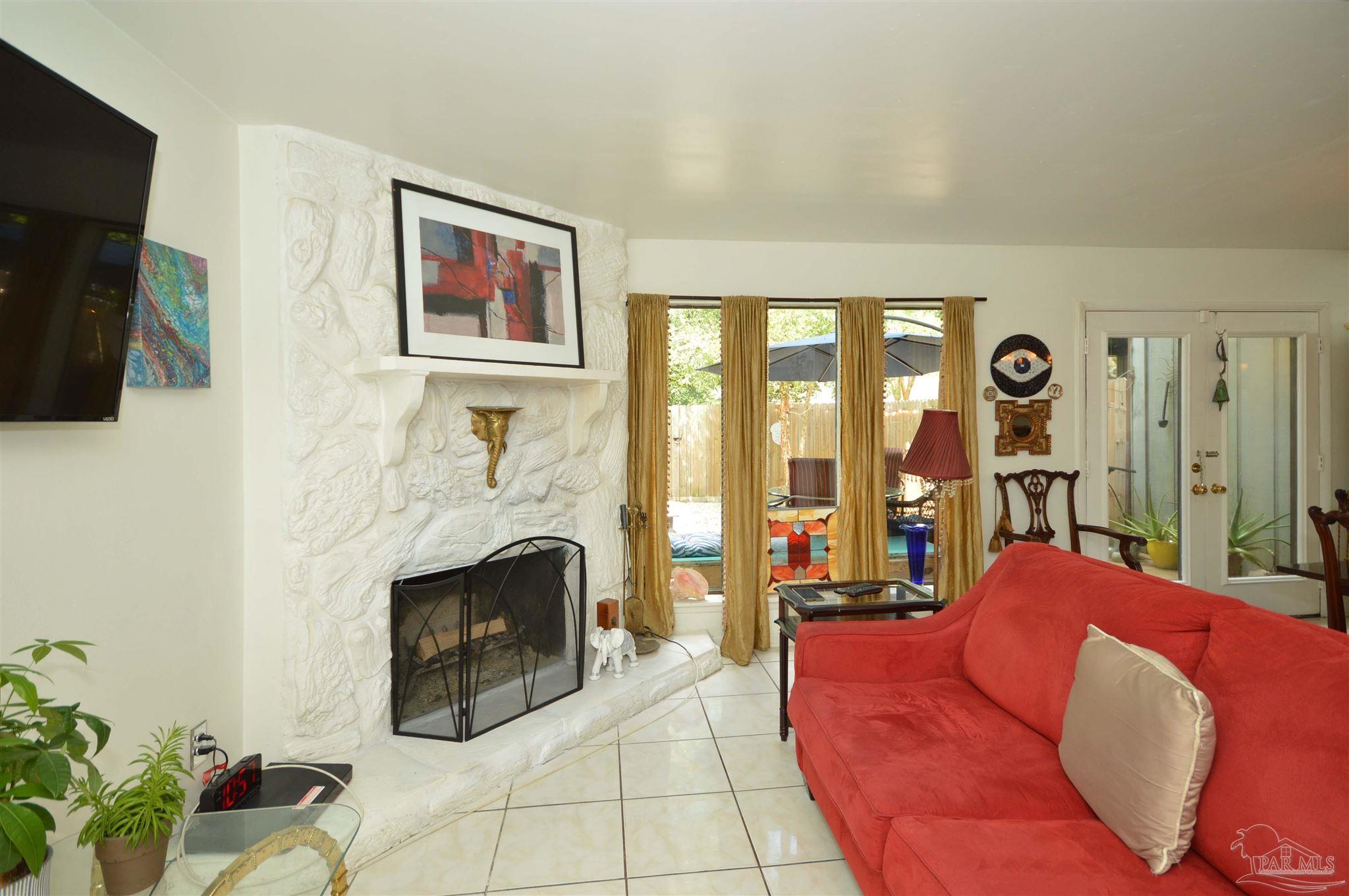 6079 Hilburn Road Pensacola, FL 32504 - Photo 7 of 48 fireplace, tile floors, open to dining