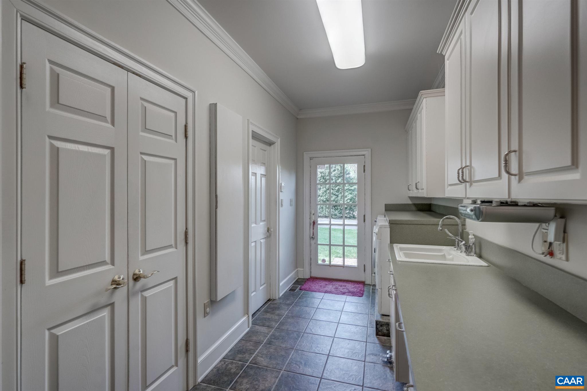 3128 Darby Road Keswick, VA 22947 - Photo 49 of 62 a kitchen with granite countertop a refrigerator and a sink