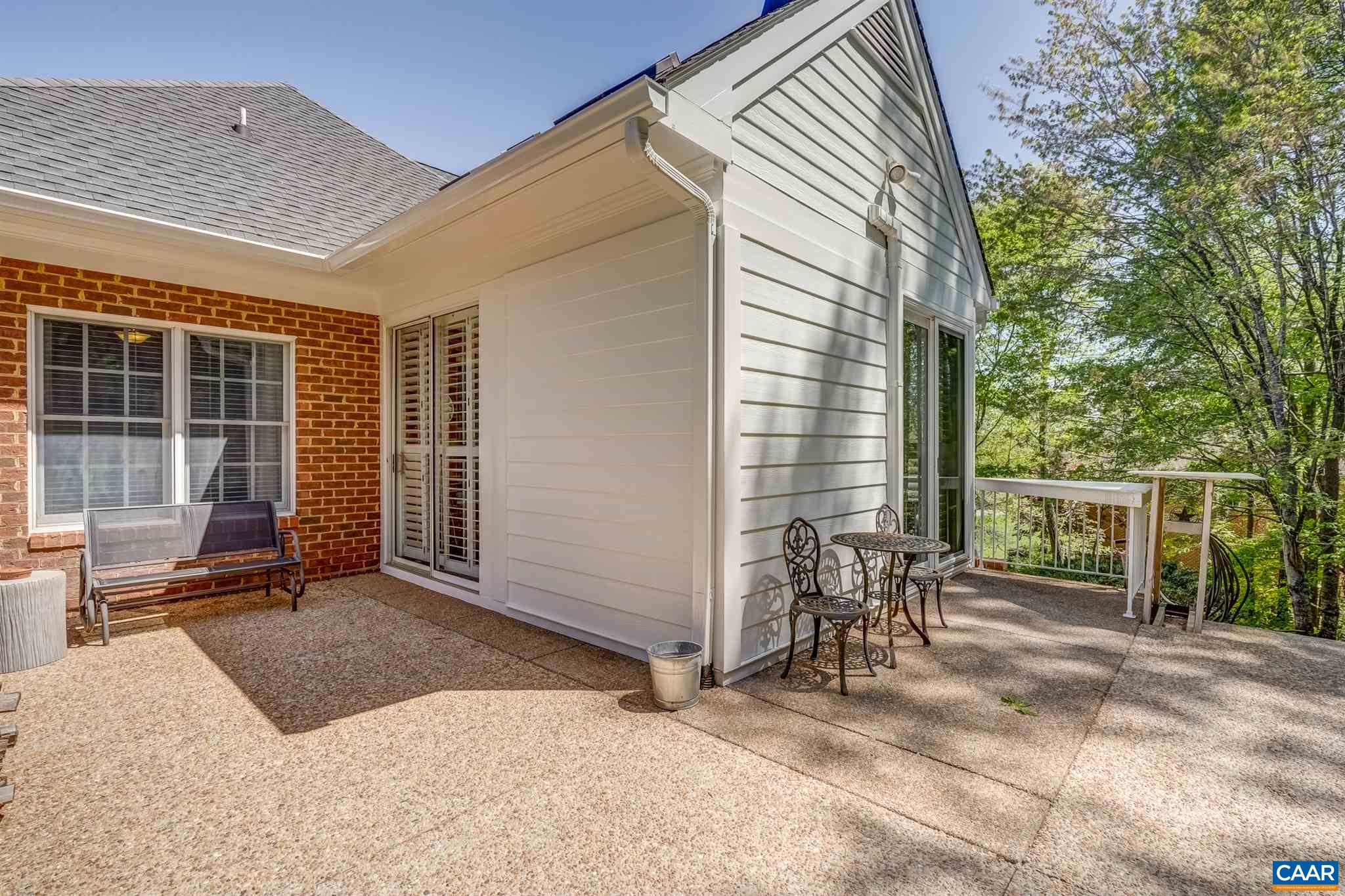 3128 Darby Road Keswick, VA 22947 - Photo 51 of 62 a view of a patio with table and chairs and floor to ceiling window and wooden fence