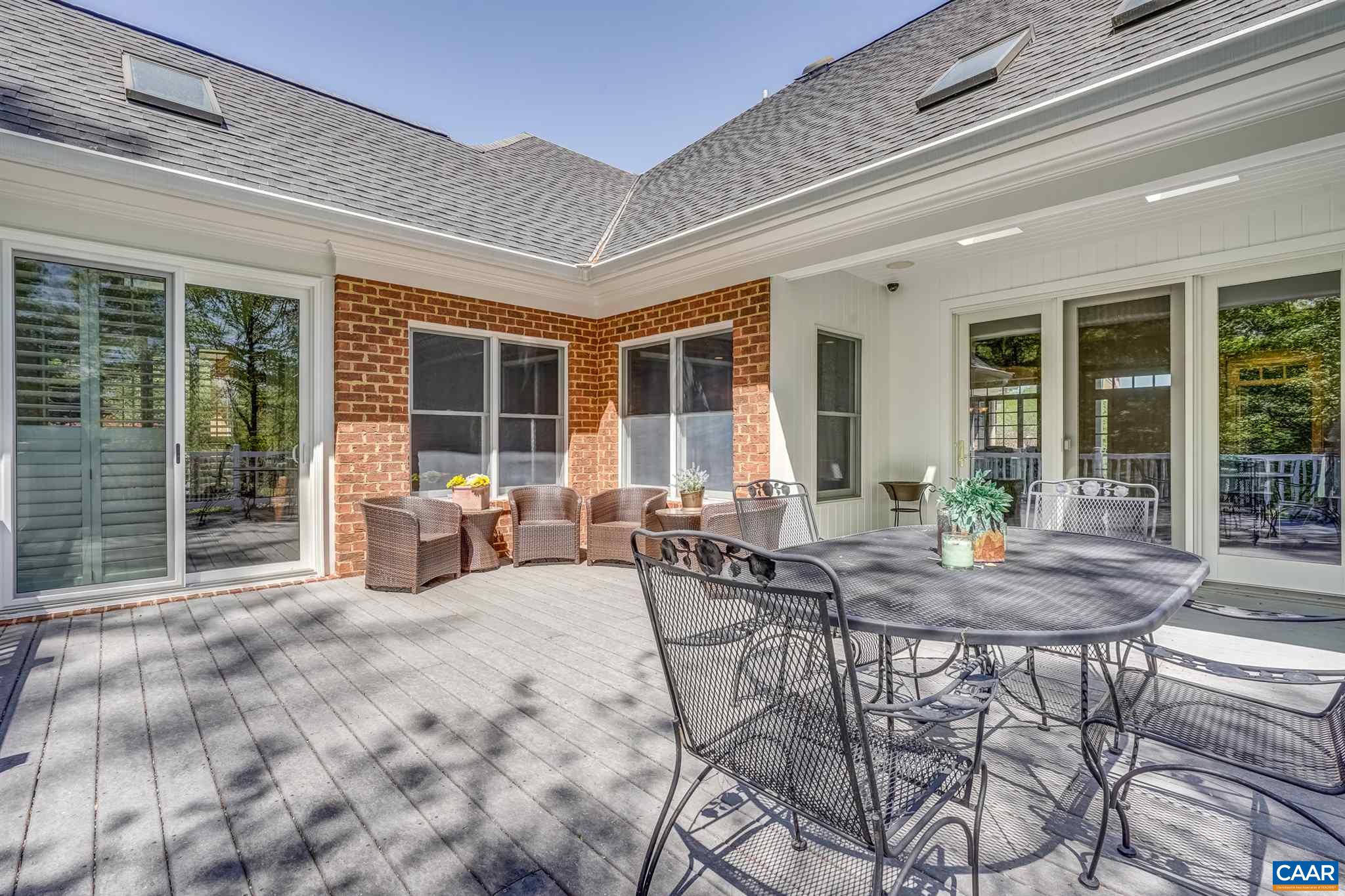 3128 Darby Road Keswick, VA 22947 - Photo 54 of 62 a view of a patio with table and chairs and wooden floor