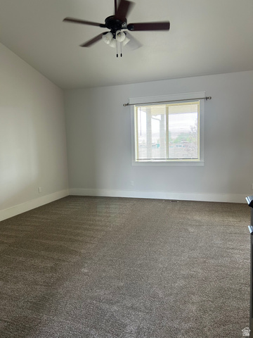 175 North 100th West Centerfield, UT 84622 - Photo 9 of 32 Spacious room featuring neutral carpeting, white baseboards, and a ceiling fan with integrated lighting