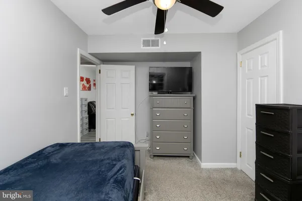 a bedroom with a dresser and a mirror