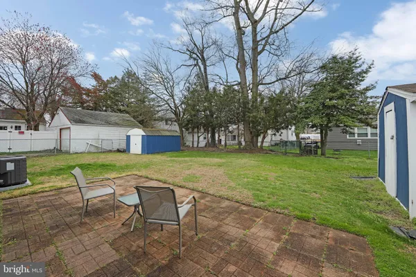 a swimming pool with outdoor seating and yard