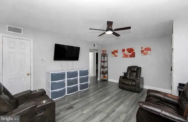 a living room with furniture windows and flat screen tv