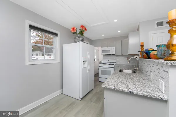a kitchen with refrigerator and window