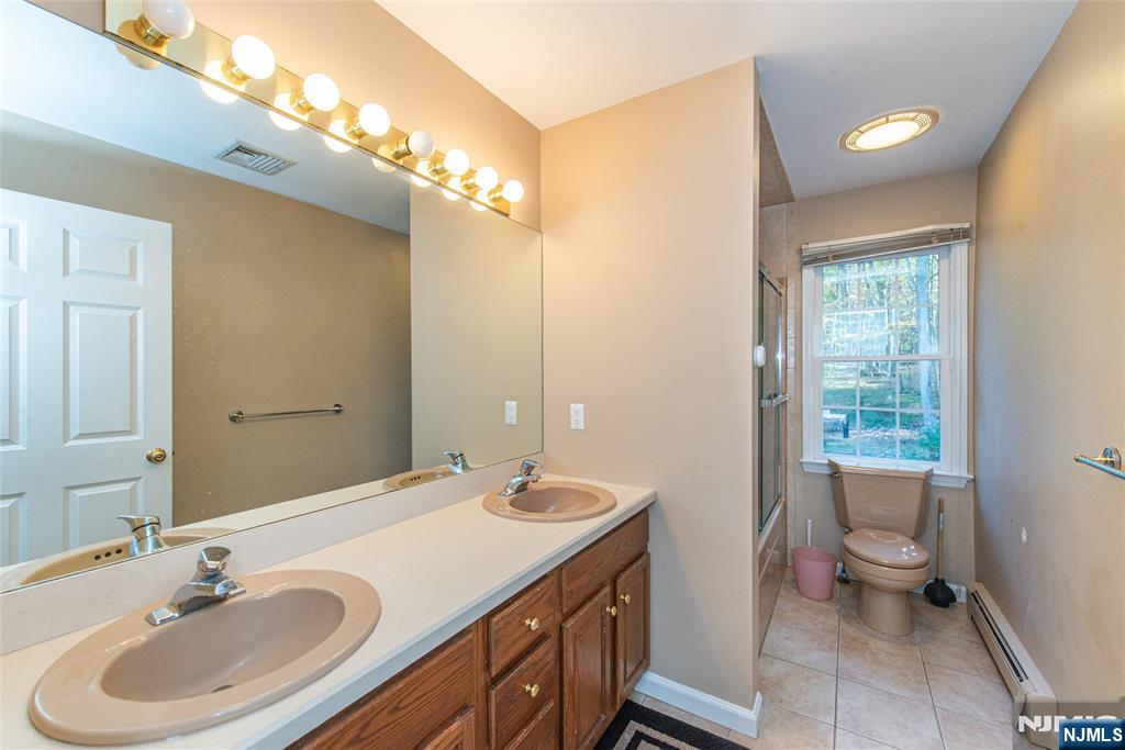 190 Andover Mohawk Road Andover, NJ 07821 - Photo 15 of 45 a bathroom with a sink double vanity and a toilet