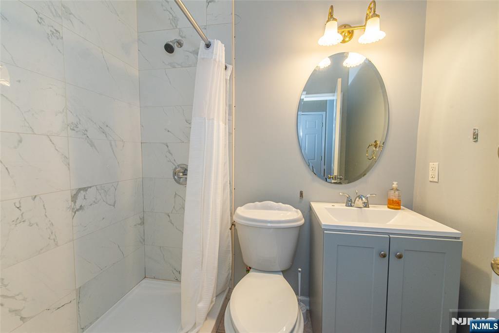 190 Andover Mohawk Road Andover, NJ 07821 - Photo 18 of 45 a bathroom with a toilet sink and mirror