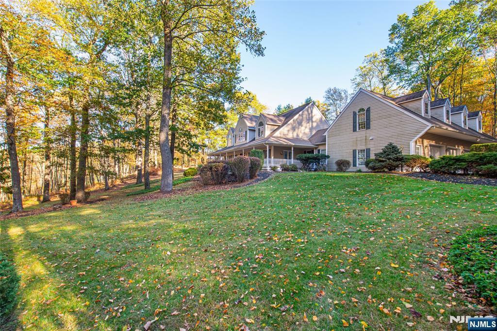 190 Andover Mohawk Road Andover, NJ 07821 - Photo 3 of 45 a front view of a house with a yard and trees