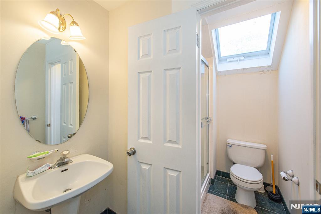 190 Andover Mohawk Road Andover, NJ 07821 - Photo 39 of 45 a bathroom with a toilet sink and mirror