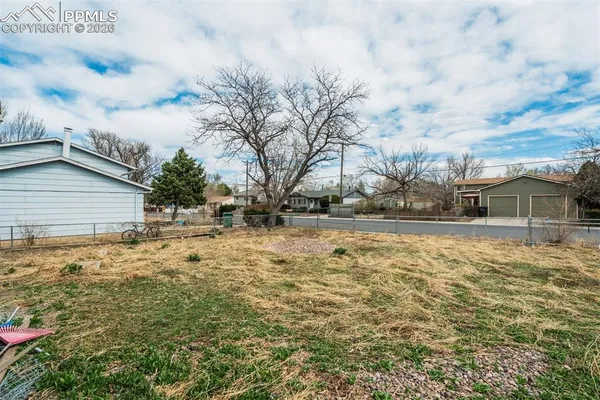 a view of yard with wooden fence