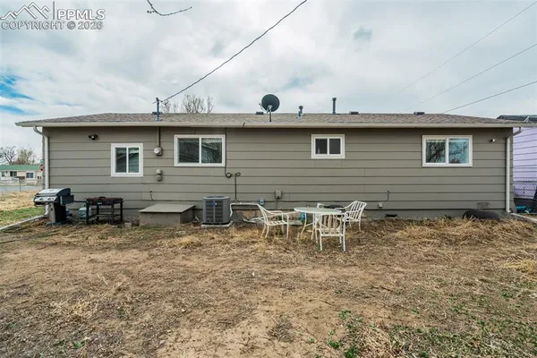 a view of a house with yard and sitting area