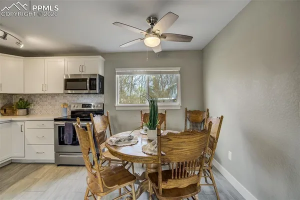a view of a dining room with furniture window and wooden floor