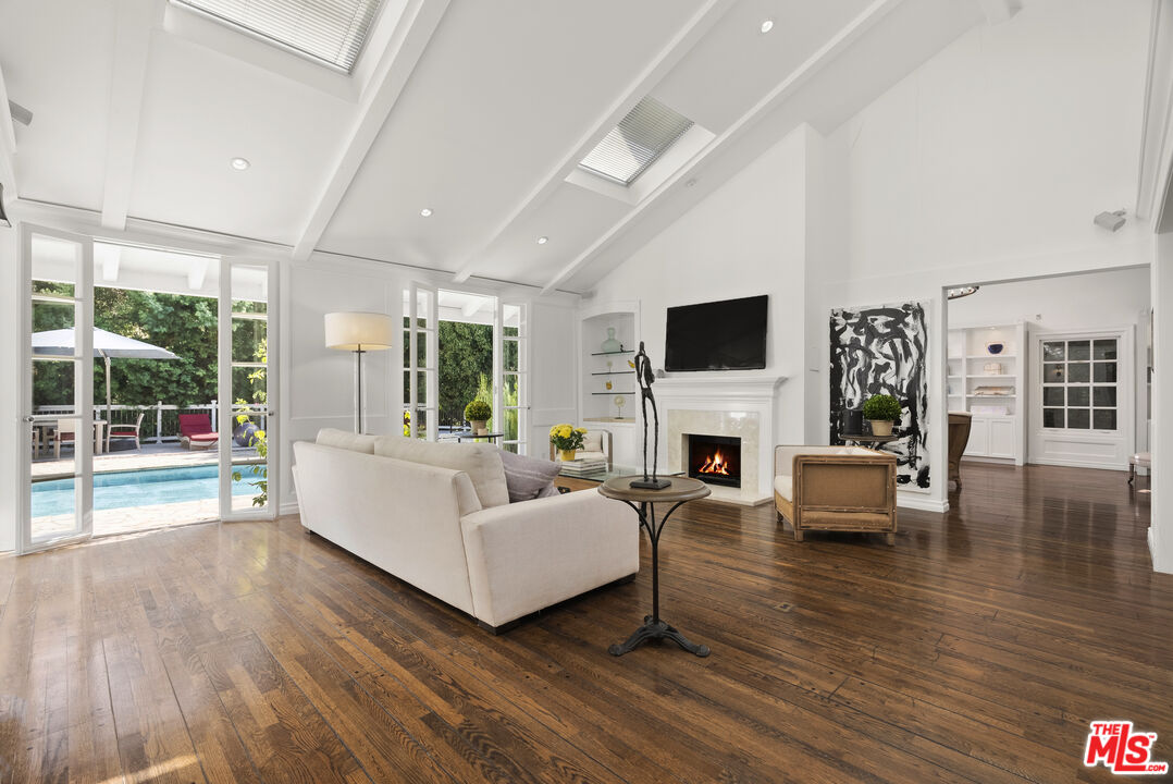 a living room with fireplace furniture and a floor to ceiling window