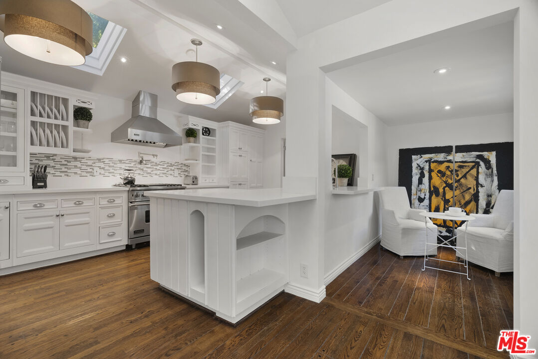 2761 Hutton Drive Beverly Hills, CA 90210 - Photo 12 of 29 a large white kitchen with a lot of counter space and wooden floor