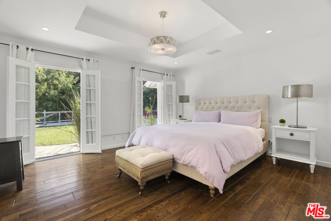 2761 Hutton Drive Beverly Hills, CA 90210 - Photo 16 of 29 a bedroom with a bed and a large window with outer view